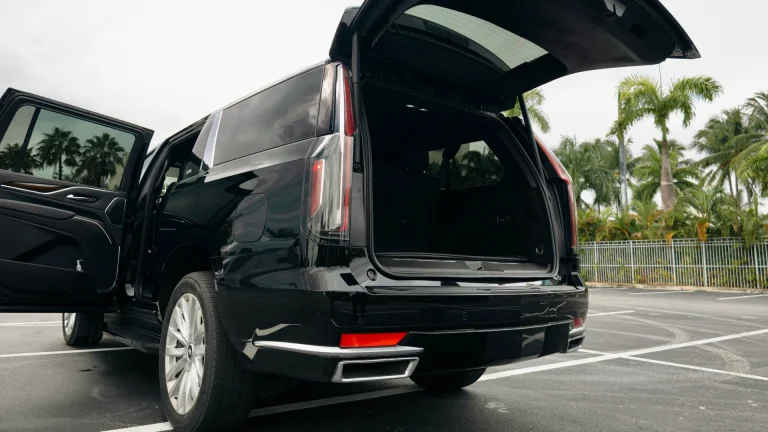 Open rear hatch of a black Escalade showing the luggage space