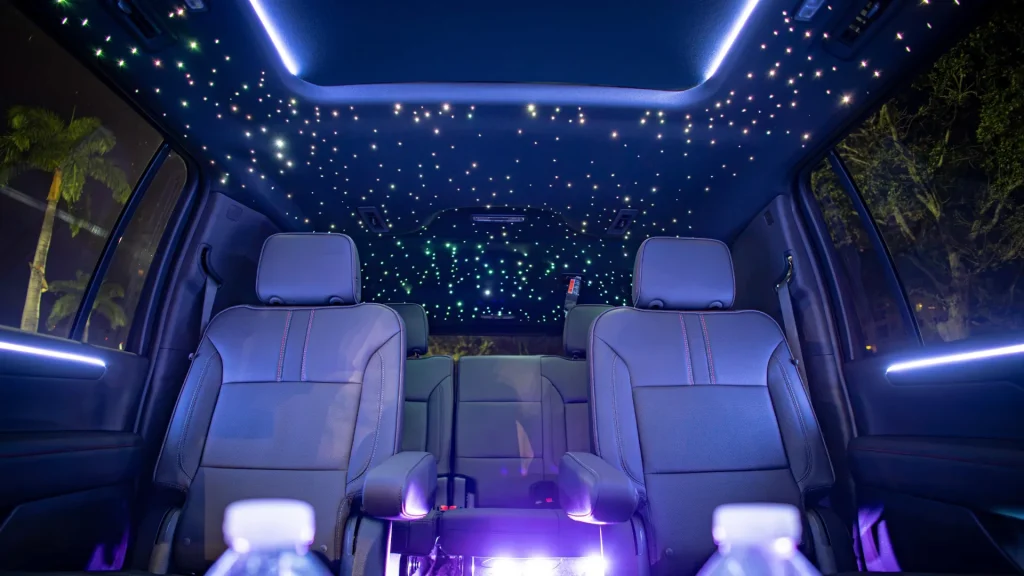 Starlight headliner glowing above two leather captain's chairs inside the ART Suburban RST